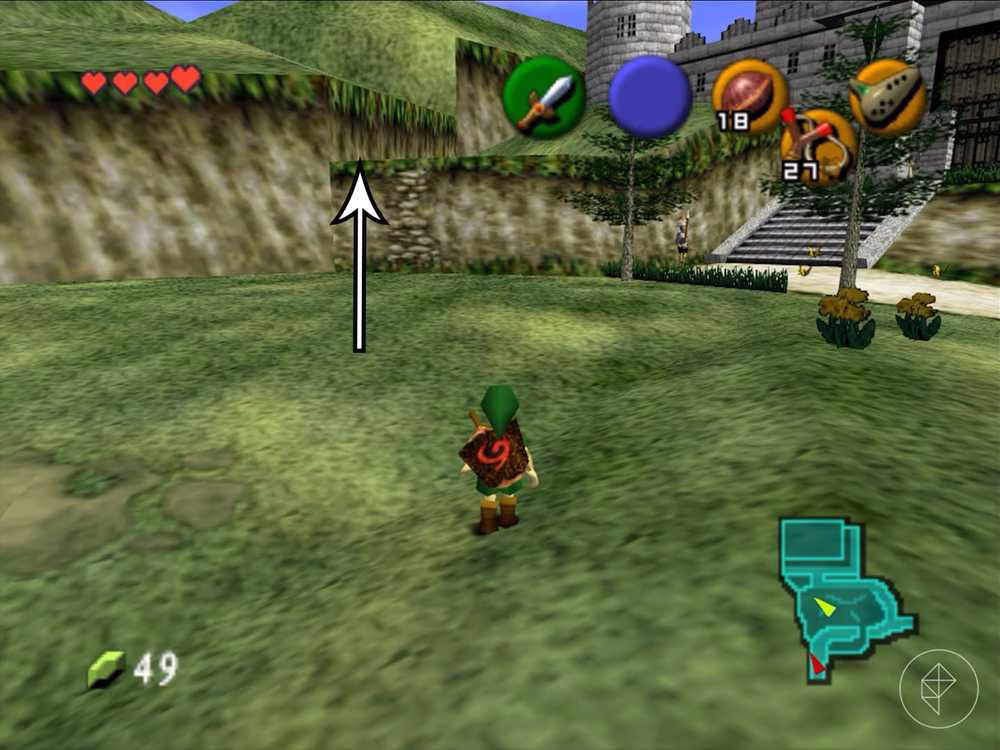 Link em uma &aacute;rea gramada diante de uma parede rochosa em Ocarina of Time.